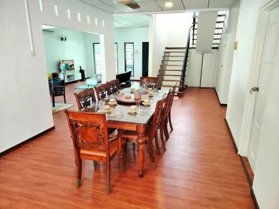 a dining room with a long table and wooden chairs at PUTIH Ipoh SaltWater Pool BBQ 5Bed4Bath 19pax in Ipoh