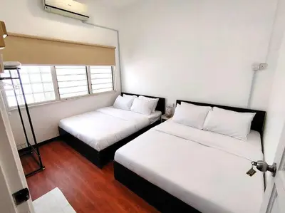a room with two beds and a window at PUTIH Ipoh SaltWater Pool BBQ 5Bed4Bath 19pax in Ipoh