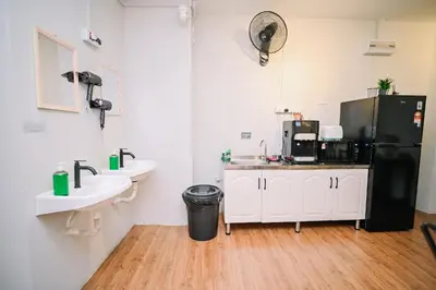 a bathroom with two sinks and a black refrigerator at Swing & Pillows - Armenian Victoria , Georgetown Penang in George Town