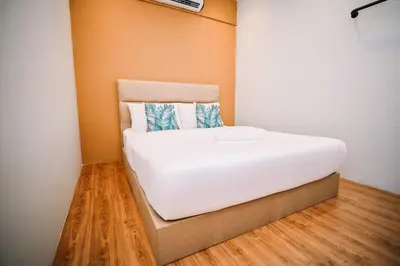 a large white bed in a room with wood floors at Swing & Pillows - Armenian Victoria , Georgetown Penang in George Town