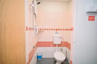 a bathroom with a toilet and a shower at Swing & Pillows - Armenian Victoria , Georgetown Penang in George Town