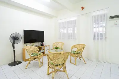 a living room with a table and chairs and a tv at Sweet 9ight Menglembu Falim Homestay in Ipoh