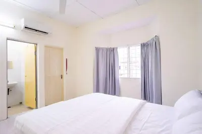 a white bedroom with a bed and a window at Sweet 9ight Menglembu Falim Homestay in Ipoh