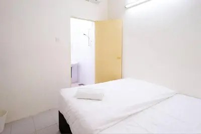 a white bed in a white room with a window at Sweet 9ight Menglembu Falim Homestay in Ipoh