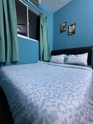 a blue bedroom with a bed with blue walls at skyview relax 2BR 1car park arenaspice airport domestic guest only in Bayan Lepas