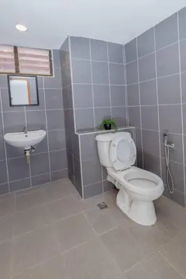 a bathroom with a toilet and a sink at Sri Sayang at Batu Feringghi Beach by Plush in Ayer Itam