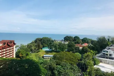 an aerial view of a city with trees and the ocean at Sri Sayang at Batu Feringghi Beach by Plush in Ayer Itam