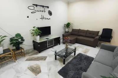 a living room with a couch and a tv at 66 Homestay 5 Min to Leaning Tower in Teluk Intan