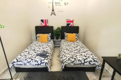 two beds sitting next to each other in a room at 66 Homestay 5 Min to Leaning Tower in Teluk Intan
