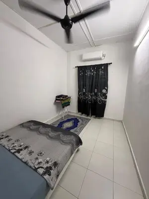 a room with a bed and a ceiling fan at Mom House in Ipoh