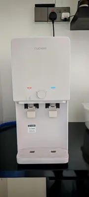 a white machine sitting on top of a table at 23 Inn Singlebed Room with share bathroom in Bukit Mertajam