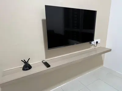 a flat screen tv sitting on a shelf in a bathroom at Ipoh Town Anderson Hani Suite 4paxs 1R1B in Ipoh
