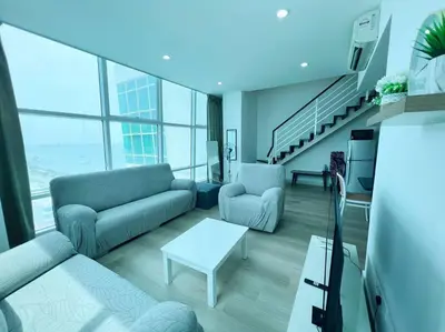 a living room with a couch and a table at Maritime Suite Duplex 3Bedroom at George Town by Uptrend Home Management in George Town