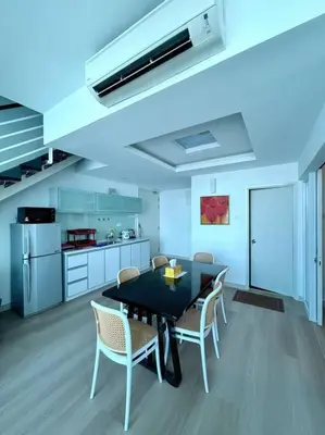 a kitchen with a table and chairs in a room at Maritime Suite Duplex 3Bedroom at George Town by Uptrend Home Management in George Town