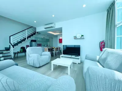 a living room with two couches and a tv at Maritime Suite Duplex 3Bedroom at George Town by Uptrend Home Management in George Town