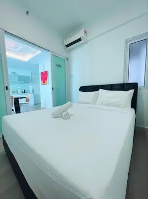 a large white bed in a room with a table at Maritime Suite Duplex 3Bedroom at George Town by Uptrend Home Management in George Town