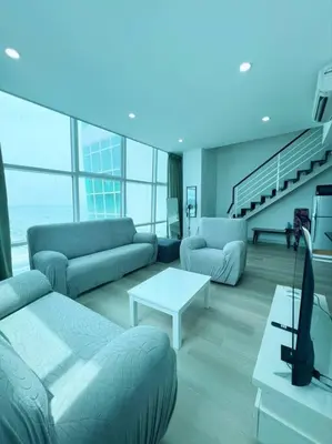 a living room with couches and a tv in a building at Maritime Suite Duplex 3Bedroom at George Town by Uptrend Home Management in George Town