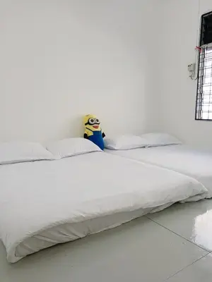 a white bed with a stuffed animal sitting on top of it at 9pax -Taman Bagan Butterworth -Budget Homestay in Butterworth