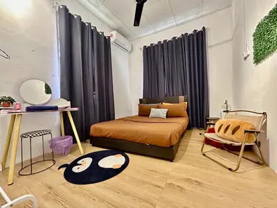 a bedroom with a bed and a chair in it at Home95#4pax#BukitMertajam in Bukit Mertajam
