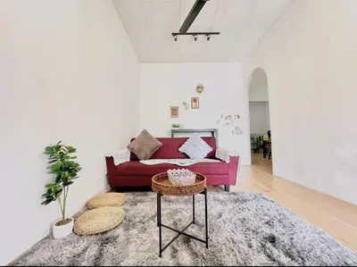a living room with a red couch and a table at Home95#4pax#BukitMertajam in Bukit Mertajam