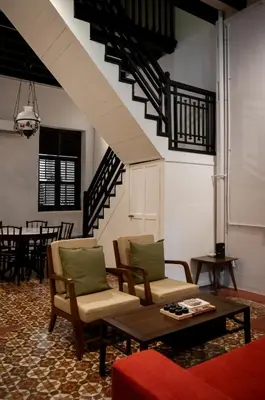 a living room with two chairs and a coffee table at Carnarvon Villa by Aayu George Town Penang in George Town