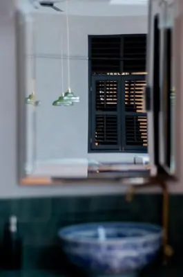 a microwave in a kitchen with a bowl on a counter at Carnarvon Villa by Aayu George Town Penang in George Town