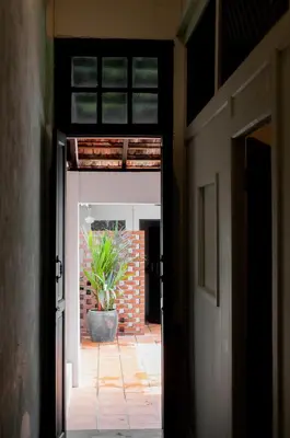 an open door to a patio with a potted plant at Carnarvon Villa by Aayu George Town Penang in George Town