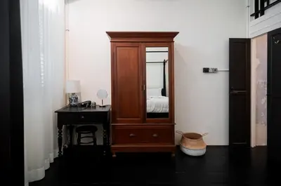 a bedroom with a dresser and a mirror and a desk at Carnarvon Villa by Aayu George Town Penang in George Town