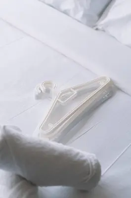 a white napkin with a plastic napkin holder on a bed at Seaview Tropicana218 3BR 2CP in George Town