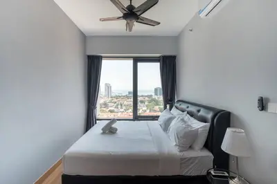 a bedroom with a bed with a ceiling fan and a window at Seaview Tropicana218 3BR 2CP in George Town