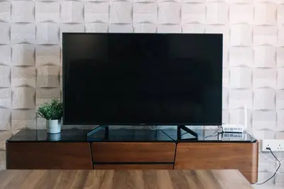 a flat screen tv sitting on top of a entertainment center at Seaview Tropicana218 3BR 2CP in George Town