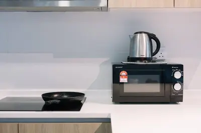 a microwave sitting on top of a kitchen counter at Seaview Tropicana218 3BR 2CP in George Town