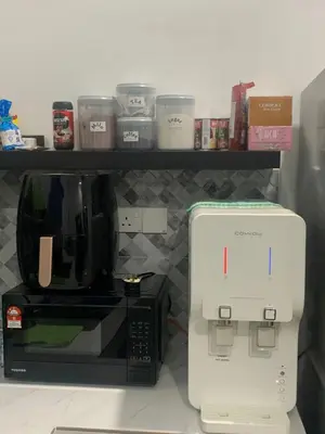 a coffee maker and a coffeemaker in a kitchen at HomeStay Damia in Teluk Intan