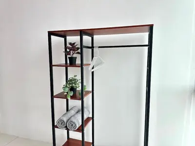 a black book shelf with a plant and a lamp at Superb Airport 2BR Suite# Straits Intl# MsgChair in Bayan Lepas