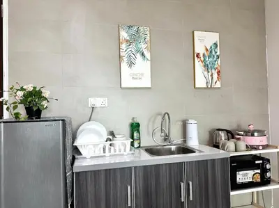 a kitchen with a sink and a counter top at Superb Airport 2BR Suite# Straits Intl# MsgChair in Bayan Lepas