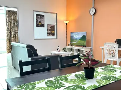 a living room with a couch and a table at Superb Airport 2BR Suite# Straits Intl# MsgChair in Bayan Lepas