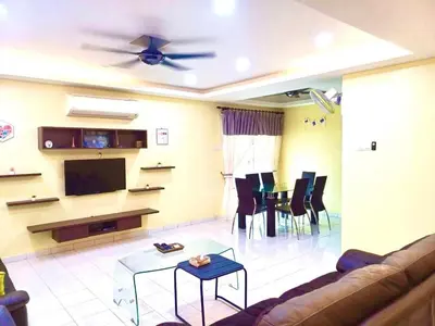 a living room with a couch and a flat screen tv at Lavender Homestay Tanjung Malim in Tanjung Malim