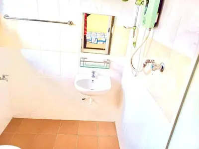 a bathroom with a sink and a toilet and a mirror at Lavender Homestay Tanjung Malim in Tanjung Malim