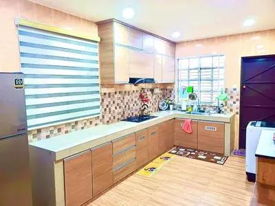 a large kitchen with wooden cabinets and a refrigerator at Lavender Homestay Tanjung Malim in Tanjung Malim