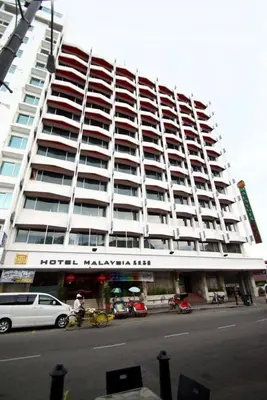 a large building with cars parked in front of it at Hotel Malaysia in George Town