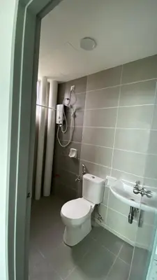 a bathroom with a toilet and a sink at The Rain Homestay Meru Raya in Ipoh