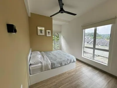 a bedroom with a bed and a large window at Eisya Homestay Emerald Avenue Brinchang in Brinchang