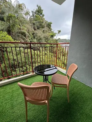 a balcony with a table and two chairs and a table at Eisya Homestay Emerald Avenue Brinchang in Brinchang