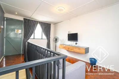 a living room with a staircase and a tv at Ipoh Hillview Boutique Guesthouse by Verve 10 pax in Ipoh