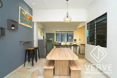 a kitchen and dining room with a wooden table at Ipoh Hillview Boutique Guesthouse by Verve 10 pax in Ipoh