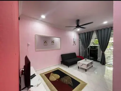 a living room with a black couch and a ceiling fan at Ammaiti Homestay Kulim in Kulim