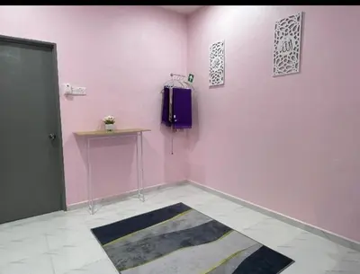 a pink room with a purple wall and a door at Ammaiti Homestay Kulim in Kulim