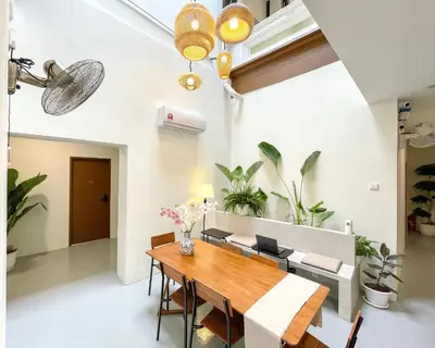 a dining room with a wooden table and chairs at INN Lebuh Melayu in George Town