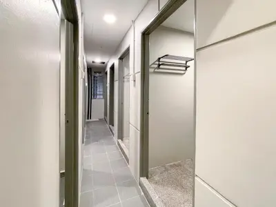 a hallway with white walls and a glass door at INN Lebuh Melayu in George Town