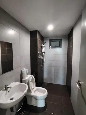 a bathroom with a white toilet and a sink at Meritus Seaview Apartment in Perai